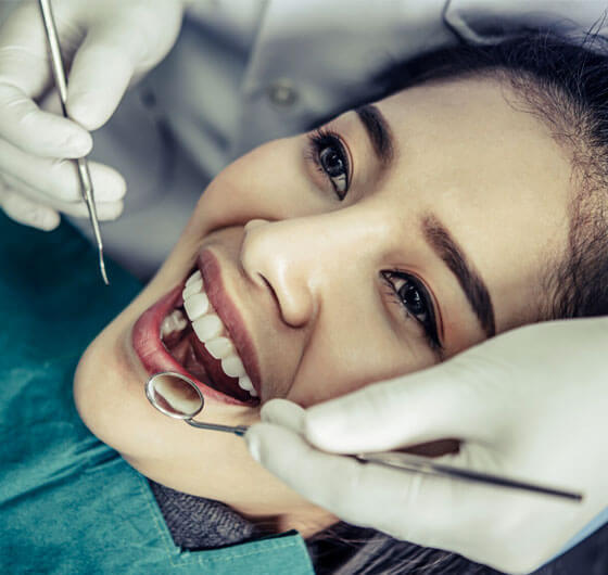 Patient receiving dental examination and treatment at routine dental visit.