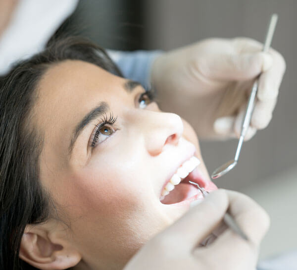 Patient receiving dental filling treatment from dentist in Portland.