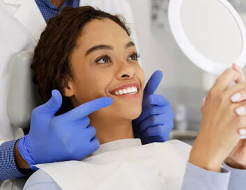 Patient smiling during dental examination with dentist in Portland dental office.