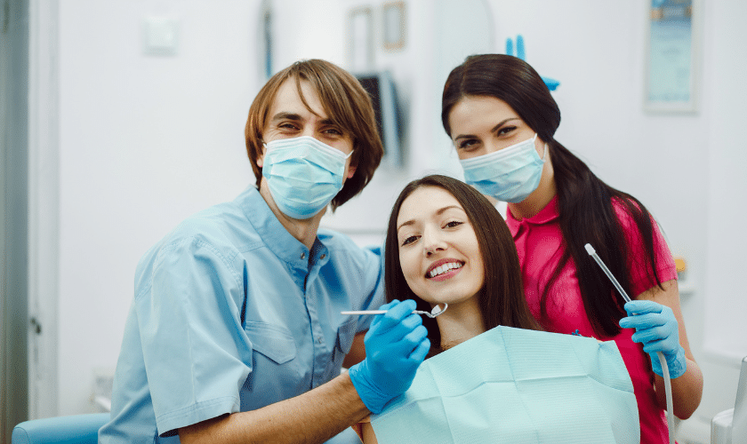Dental team with patient smiling during family dentistry appointment in Portland office.